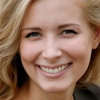 a woman smiling after receiving a botox treatment