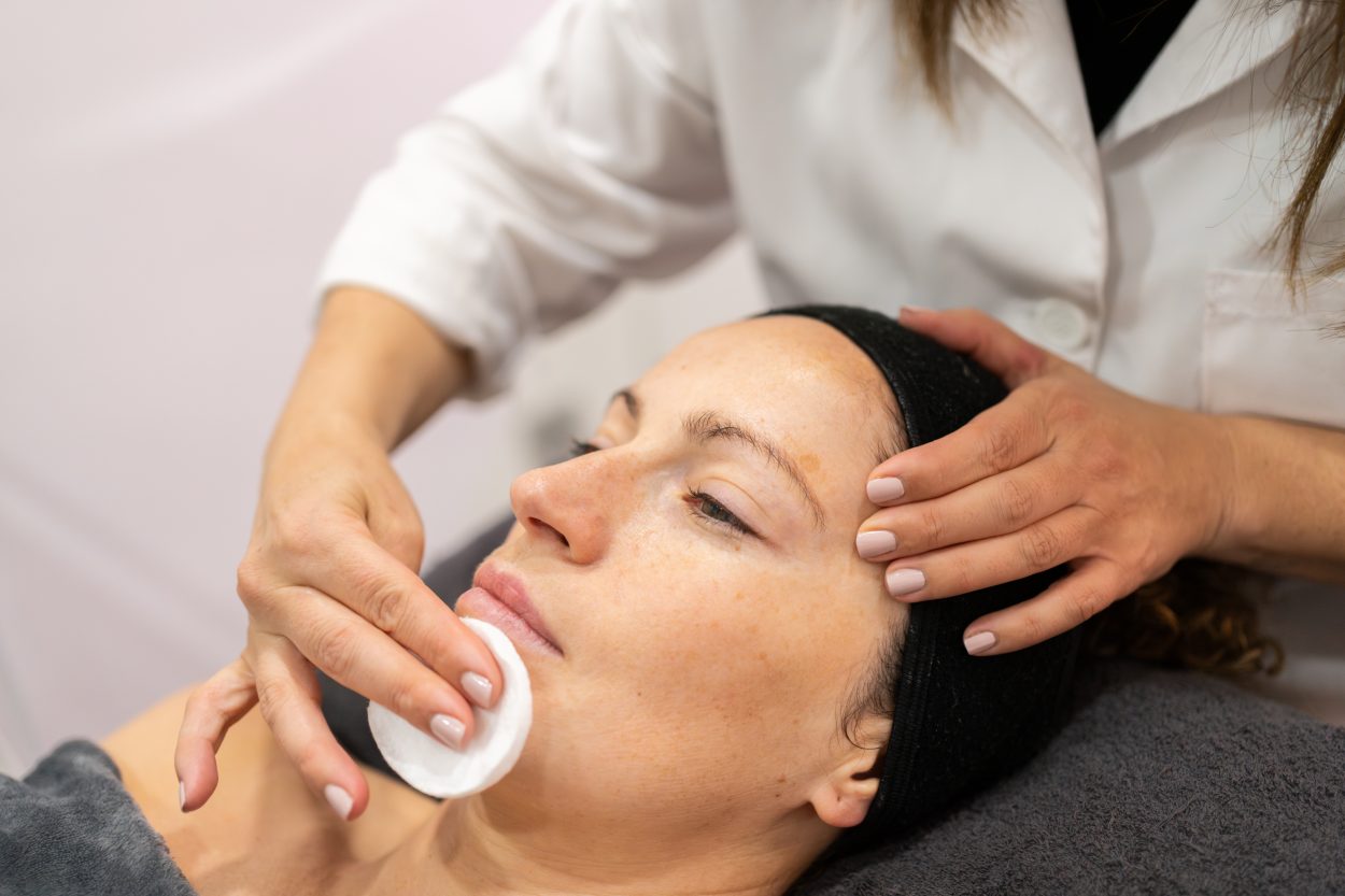 A photo of a women getting prepped for her medical facial
