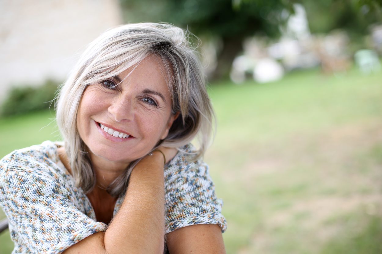 A photo of a woman smiling after joining Dr. Laurel Bailey Laser & Aesthetics VIP Membership Program