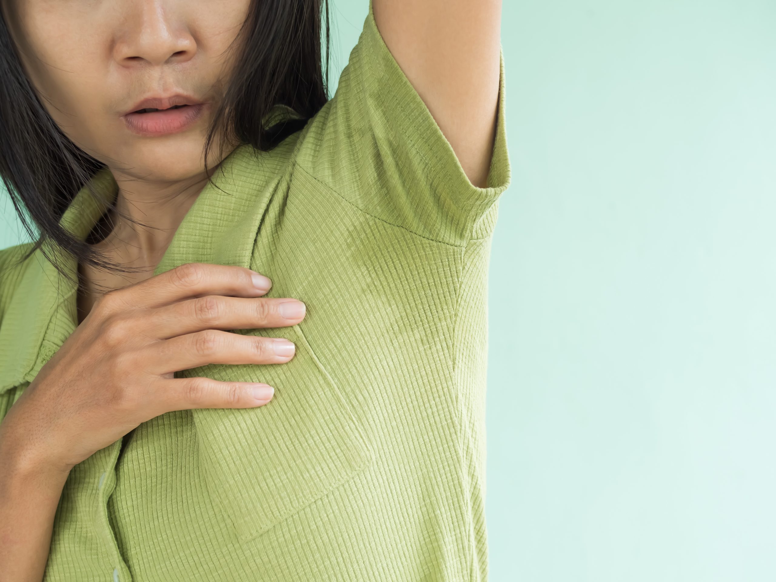 A photo of a woman who is looking to stop excessive sweating with Botox treatments for hyperhidrosis